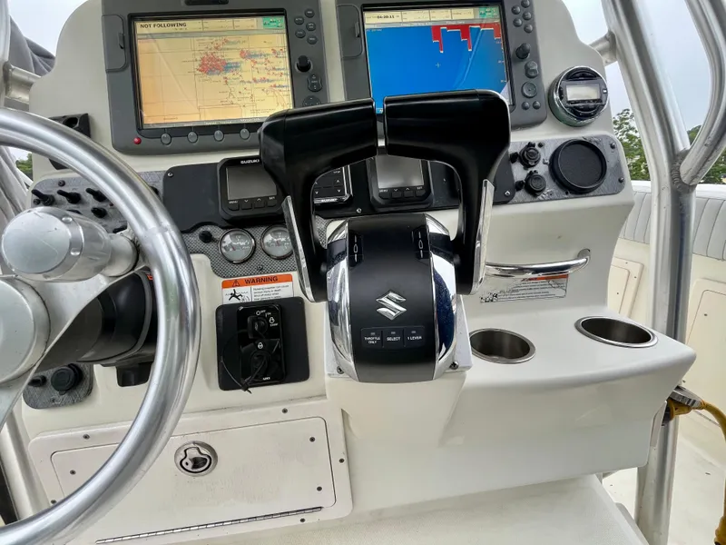 Slide: The Image of 2006 Hydra-Sports Vector 2900 CC boat dashboard with navigation screens and controls. - 15
