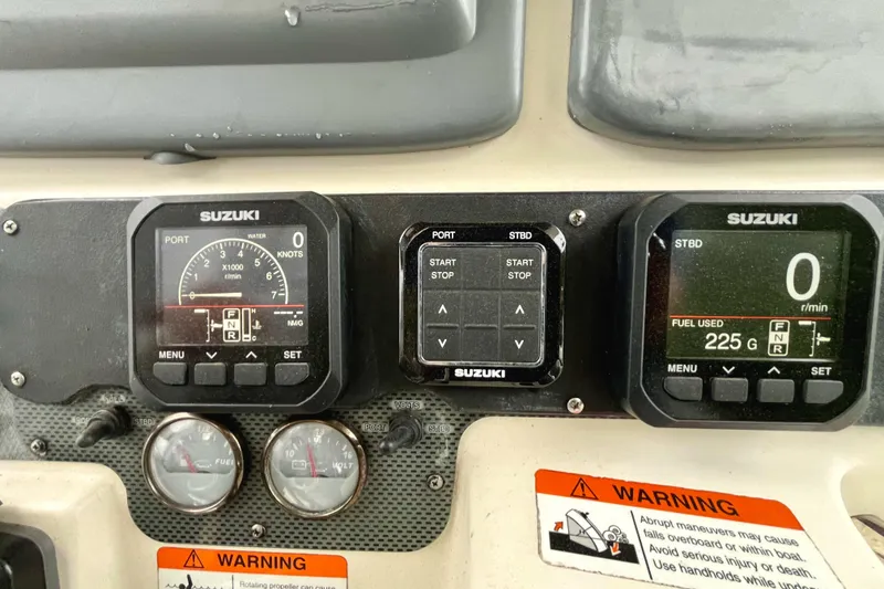 Slide: The Image of Dashboard of a 2006 Hydra-Sports Vector 2900 CC with Suzuki gauges and warning labels. - 16