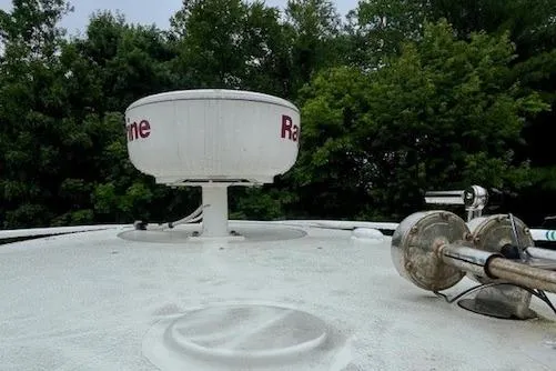 Slide: The Image of Radar equipment on a 2006 Hydra-Sports Vector 2900 CC boat, surrounded by trees. - 34