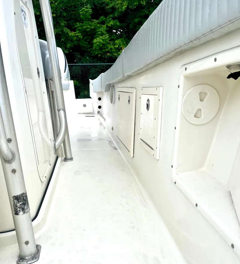 Slide: The Image of 2006 Hydra-Sports Vector 2900 CC boat interior with storage compartments and railing. - 9