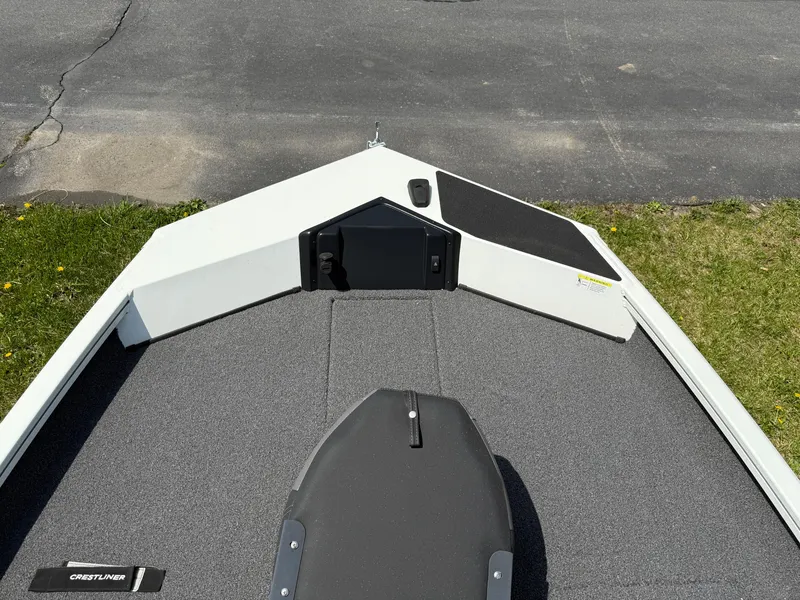 Slide: The Image of 2023 Crestliner XF 189 boat deck with gray carpet and storage compartments. - 2