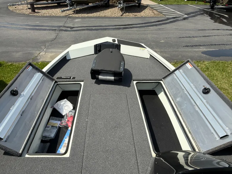 Slide: The Image of 2023 Crestliner XF 189 boat interior with open storage compartments on a sunny day. - 4