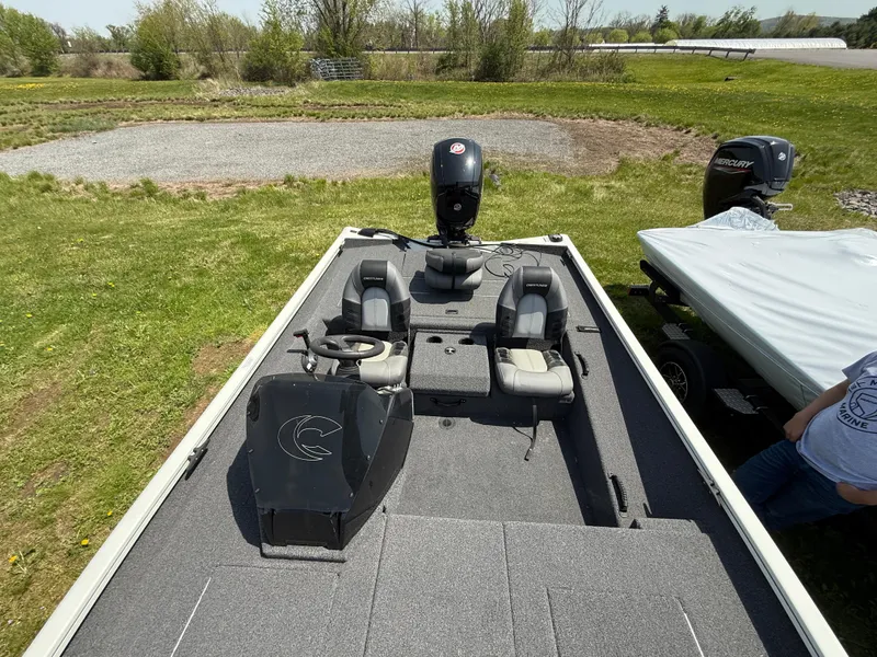Slide: The Image of 2023 Crestliner XF 189 boat with dual seats and steering console on grassy terrain. - 5