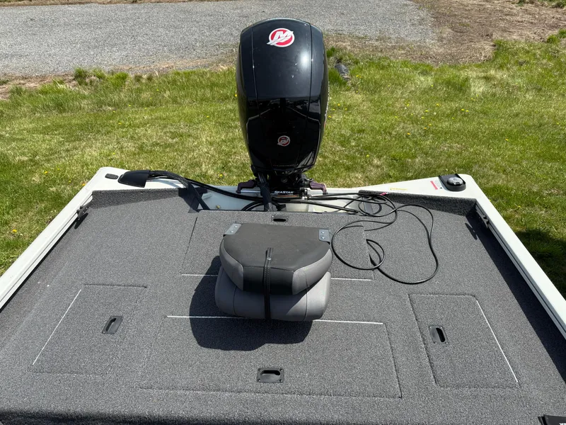 Slide: The Image of 2023 Crestliner XF 189 boat deck with motor, on grassy background. - 6