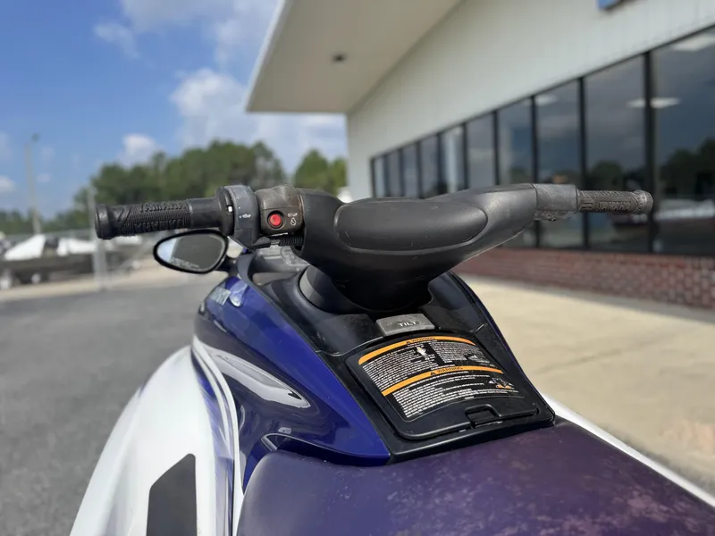 Slide: The Image of 2003 Yamaha WaveRunner FX140 handlebars and controls, parked outdoors near a building. - 5