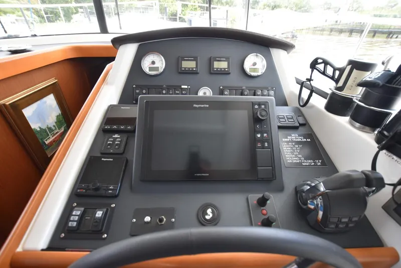 Slide: The Image of Helm station of 2019 Beneteau Swift Trawler 44 with navigation equipment and controls. - 12