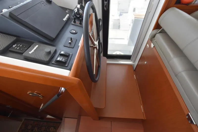 Slide: The Image of Helm station of 2019 Beneteau Swift Trawler 44 with Raymarine controls and wooden finish. - 13