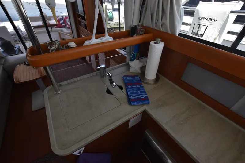 Slide: The Image of Interior of 2019 Beneteau Swift Trawler 44, featuring a compact kitchen sink area. - 14