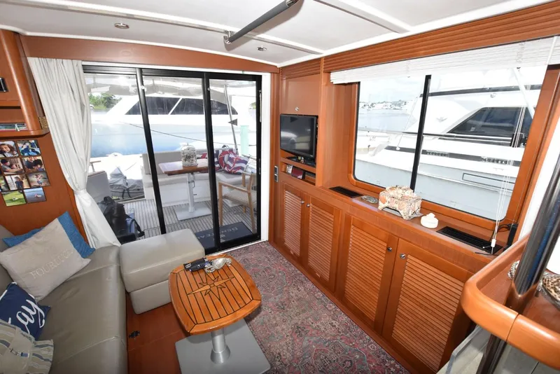 Slide: The Image of Interior of 2019 Beneteau Swift Trawler 44, featuring cozy seating and elegant wood finishes. - 16