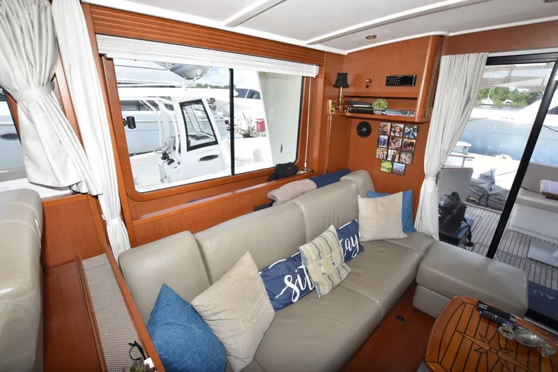 Slide: The Image of Interior of 2019 Beneteau Swift Trawler 44 with beige sofa and nautical decor. - 17
