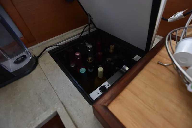 Slide: The Image of Hidden wine storage in 2019 Beneteau Swift Trawler 44 kitchen area. - 18