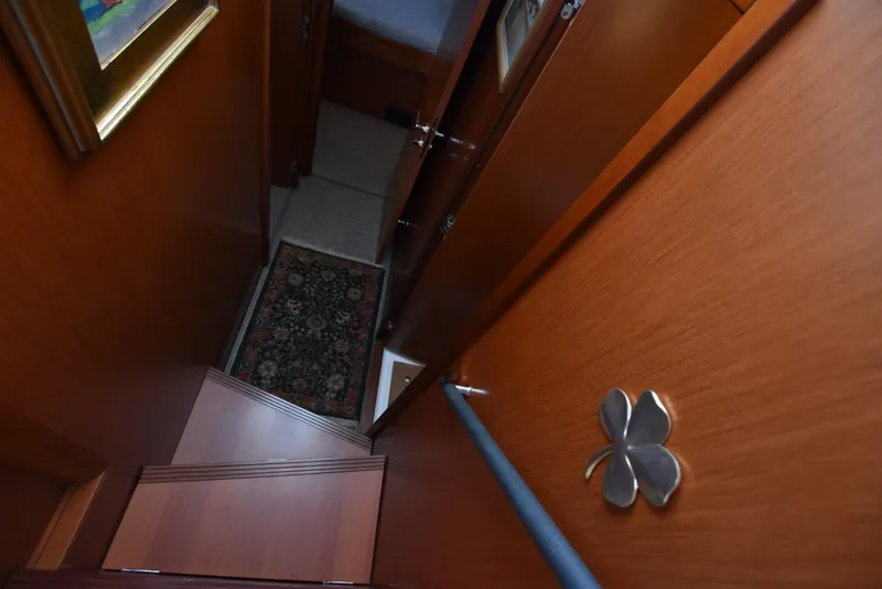 Slide: The Image of Interior view of 2019 Beneteau Swift Trawler 44, featuring wooden stairs and decorative elements. - 19