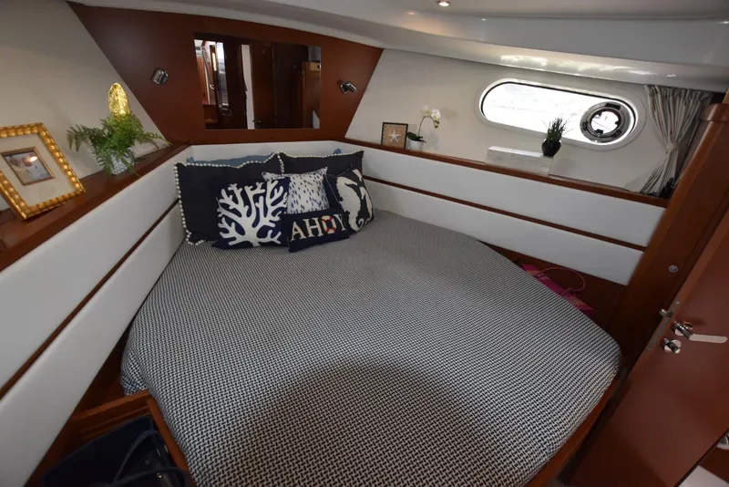 Slide: The Image of Cozy bedroom in 2019 Beneteau Swift Trawler 44 with nautical decor and porthole window. - 21