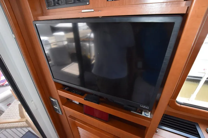 Slide: The Image of Flat-screen TV in 2019 Beneteau Swift Trawler 44 interior, wooden paneling. - 25