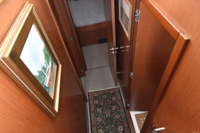 Slide: The Image of Interior hallway of 2019 Beneteau Swift Trawler 44 with wood paneling and artwork. - 26