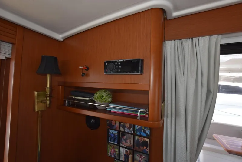 Slide: The Image of Interior of 2019 Beneteau Swift Trawler 44 with wooden shelves and decor. - 29