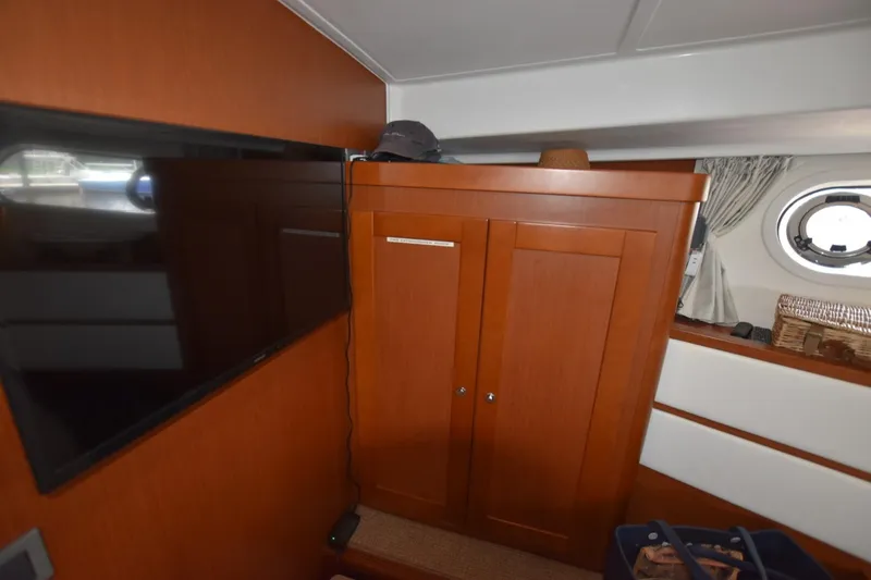 Slide: The Image of Interior of 2019 Beneteau Swift Trawler 44 with TV and wooden cabinet. - 31