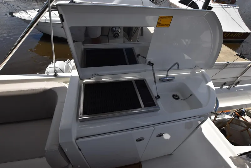 Slide: The Image of Outdoor kitchenette on 2019 Beneteau Swift Trawler 44, featuring grill and sink. - 37