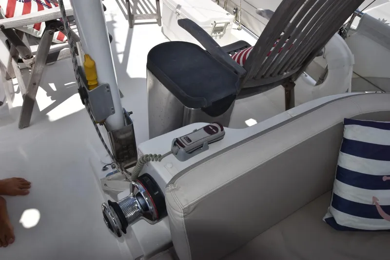 Slide: The Image of 2019 Beneteau Swift Trawler 44 deck with seating, winch, and nautical decor. - 39