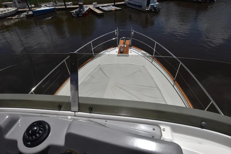 Slide: The Image of 2019 Beneteau Swift Trawler 44 bow view, docked in a marina. - 43
