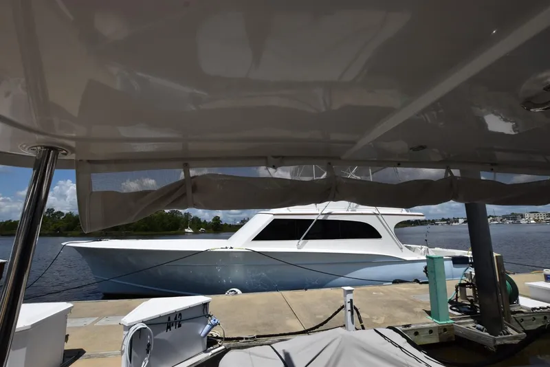 Slide: The Image of 2019 Beneteau Swift Trawler 44 docked at marina, viewed from under canopy. - 48