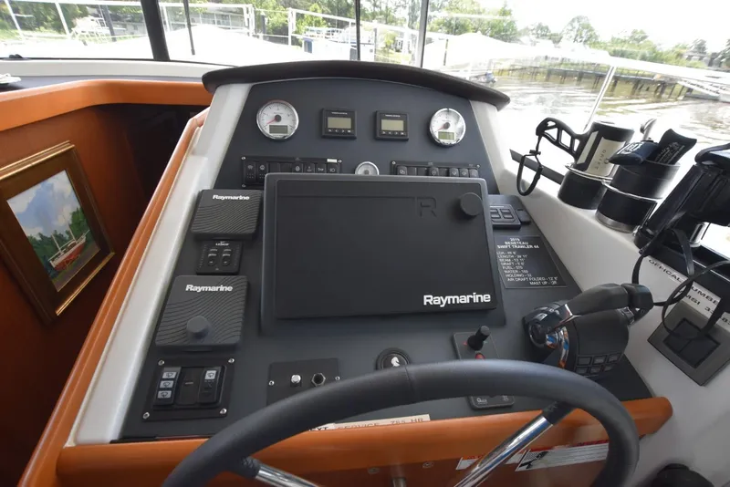 Slide: The Image of 2019 Beneteau Swift Trawler 44 helm with Raymarine navigation equipment and controls. - 9