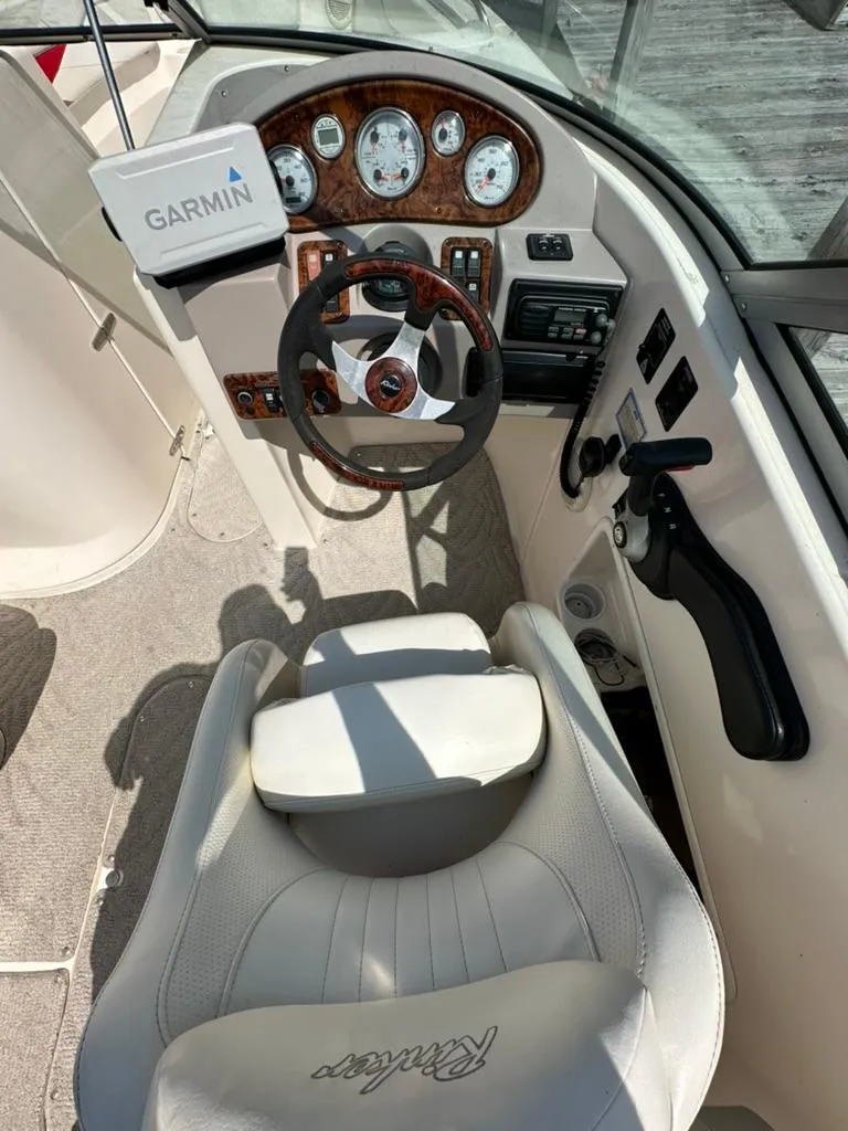 Slide: The Image of 2005 Rinker 282 Captiva Bowrider cockpit with Garmin GPS, steering wheel, and gauges. - 11