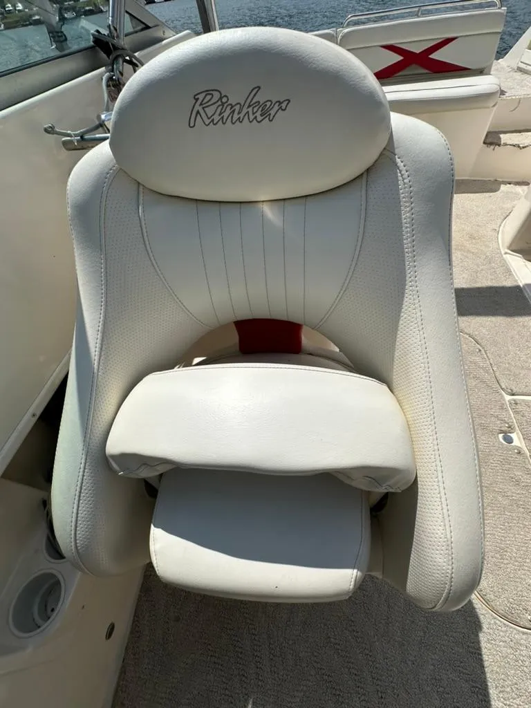 Slide: The Image of White captain's chair on 2005 Rinker 282 Captiva Bowrider boat, featuring embroidered logo. - 13