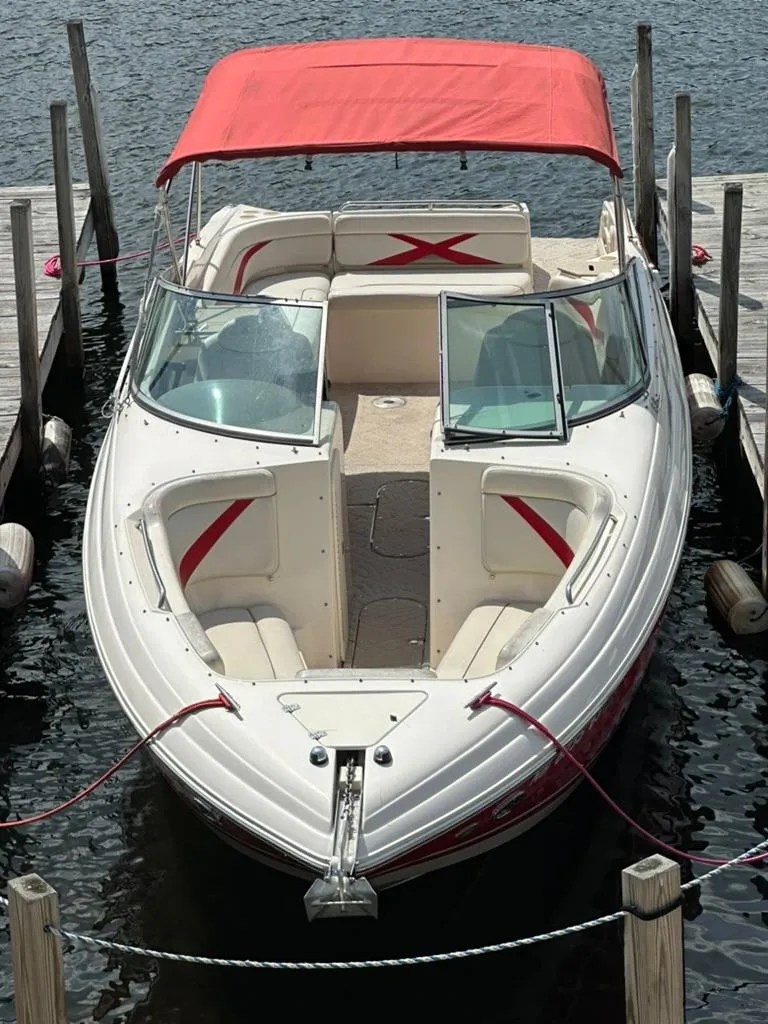 Slide: The Image of 2005 Rinker 282 Captiva Bowrider with red canopy docked on water. - 16