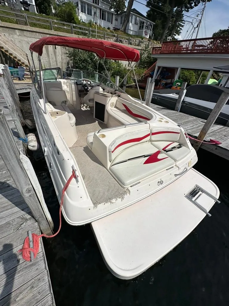 Slide: The Image of 2005 Rinker 282 Captiva Bowrider with red canopy docked at marina. - 17