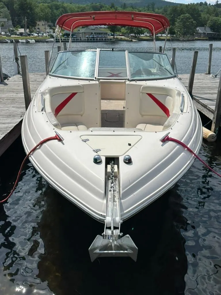 Slide: The Image of 2005 Rinker 282 Captiva Bowrider with red canopy docked on a sunny day. - 18