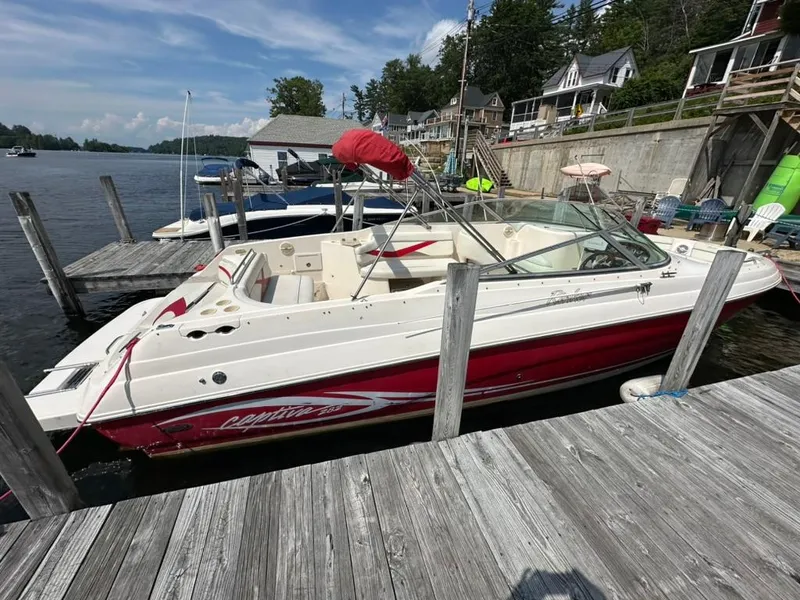 Slide: The Image of 2005 Rinker 282 Captiva Bowrider docked at a lakeside marina. - 5