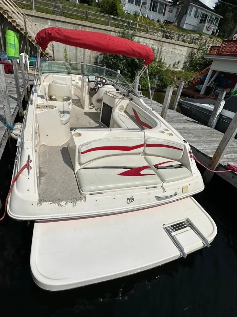 Slide: The Image of 2005 Rinker 282 Captiva Bowrider with red canopy docked at marina. - 7
