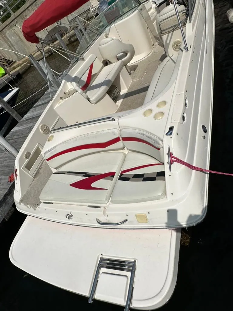 Slide: The Image of 2005 Rinker 282 Captiva Bowrider boat with red and white interior, docked at marina. - 8