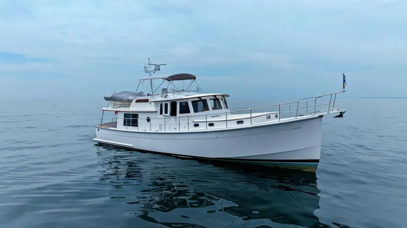 Slide: The Image of 2023 Krogen Express 52 yacht on calm ocean waters. - 13