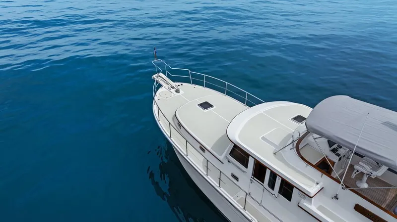 Slide: The Image of 2023 Krogen Express 52 yacht cruising on calm blue waters. - 19