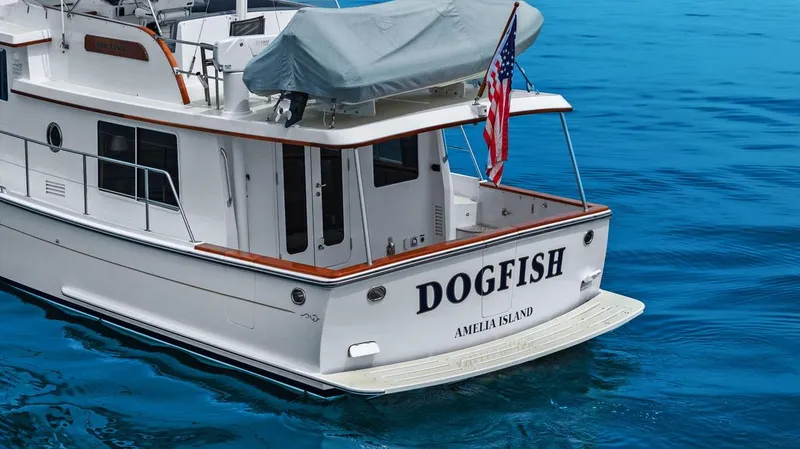 Slide: The Image of 2023 Krogen Express 52 yacht "Dogfish" on blue water, Amelia Island. - 21