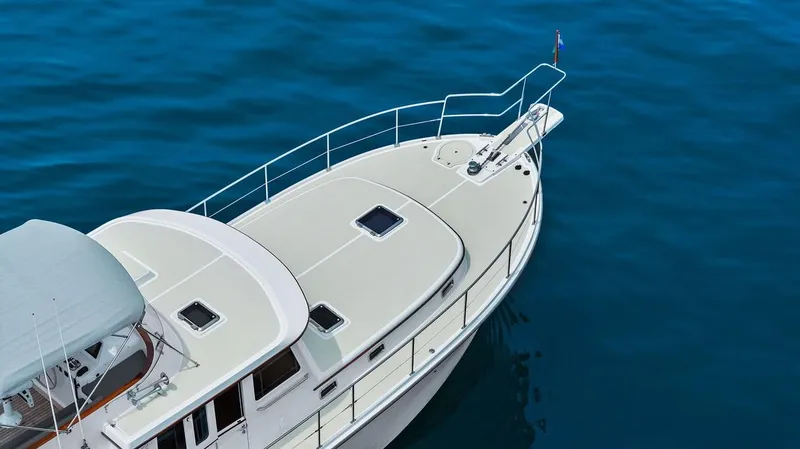 Slide: The Image of 2023 Krogen Express 52 yacht on calm blue water, top view. - 23