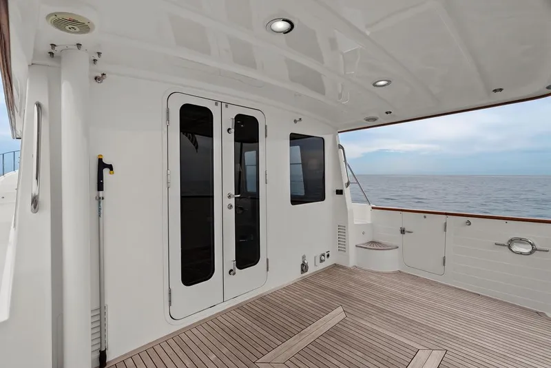 Slide: The Image of 2023 Krogen Express 52 yacht deck with ocean view, featuring sleek design and wooden flooring. - 28