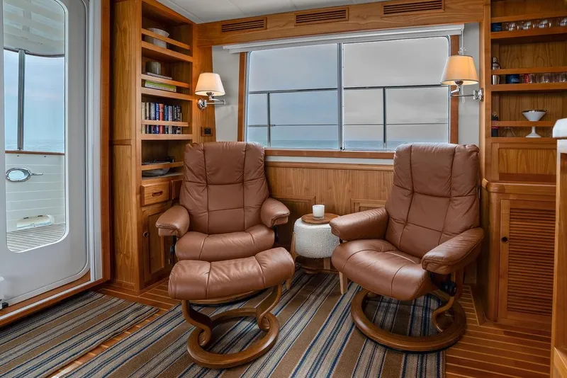 Slide: The Image of Luxurious 2023 Krogen Express 52 yacht interior with leather chairs and wooden cabinetry. - 33