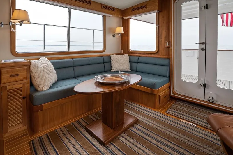 Slide: The Image of Luxurious 2023 Krogen Express 52 yacht interior with cozy seating and elegant wooden finishes. - 34