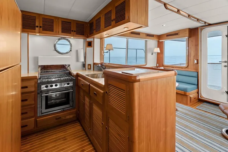 Slide: The Image of Luxurious 2023 Krogen Express 52 yacht interior with wooden cabinetry and ocean view. - 38