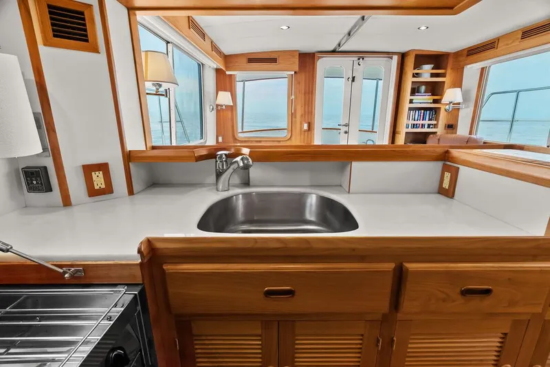 Slide: The Image of Luxurious 2023 Krogen Express 52 yacht interior with modern kitchen and ocean view. - 43