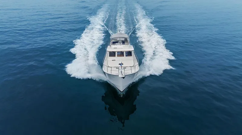 Slide: The Image of 2023 Krogen Express 52 yacht cruising on open water, aerial view. - 9