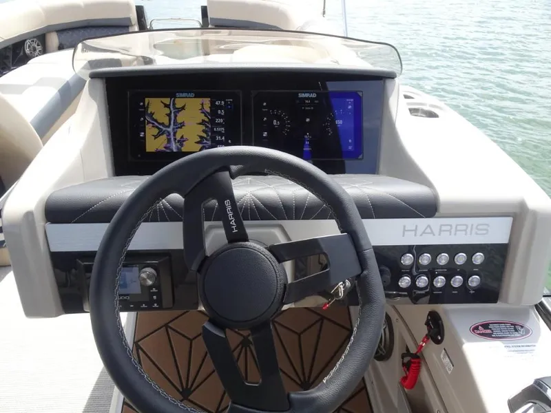 Slide: The Image of Steering console of 2025 Harris Grand Mariner 250 with advanced navigation displays. - 13