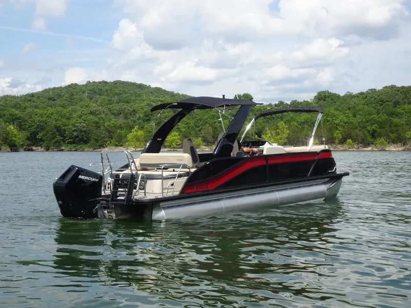 Slide: The Image of 2025 Harris Grand Mariner 250 pontoon boat on a scenic lake. - 2