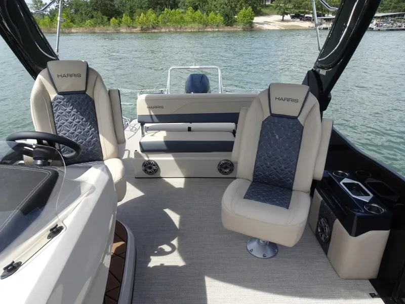 Slide: The Image of 2025 Harris Grand Mariner 250 boat interior with luxurious seating and lake view. - 21