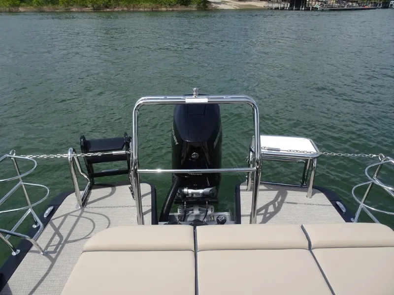 Slide: The Image of 2025 Harris Grand Mariner 250 boat with outboard motor on calm water. - 23