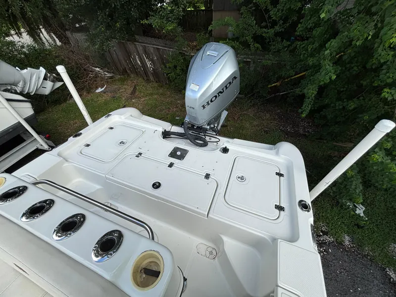 Slide: The Image of 2004 Triton LTS boat with Honda outboard motor, viewed from above, surrounded by greenery. - 10