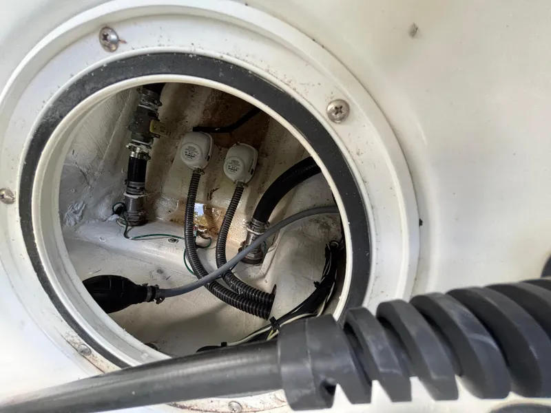 Slide: The Image of 2004 Triton LTS boat compartment showing wiring and plumbing components. - 14